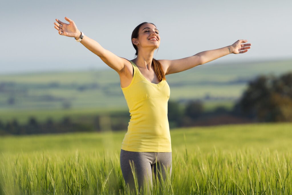beautiful young woman enjoying the spring standing in a cereal f