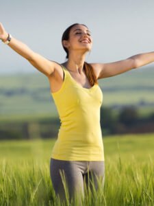 beautiful young woman enjoying the spring standing in a cereal f